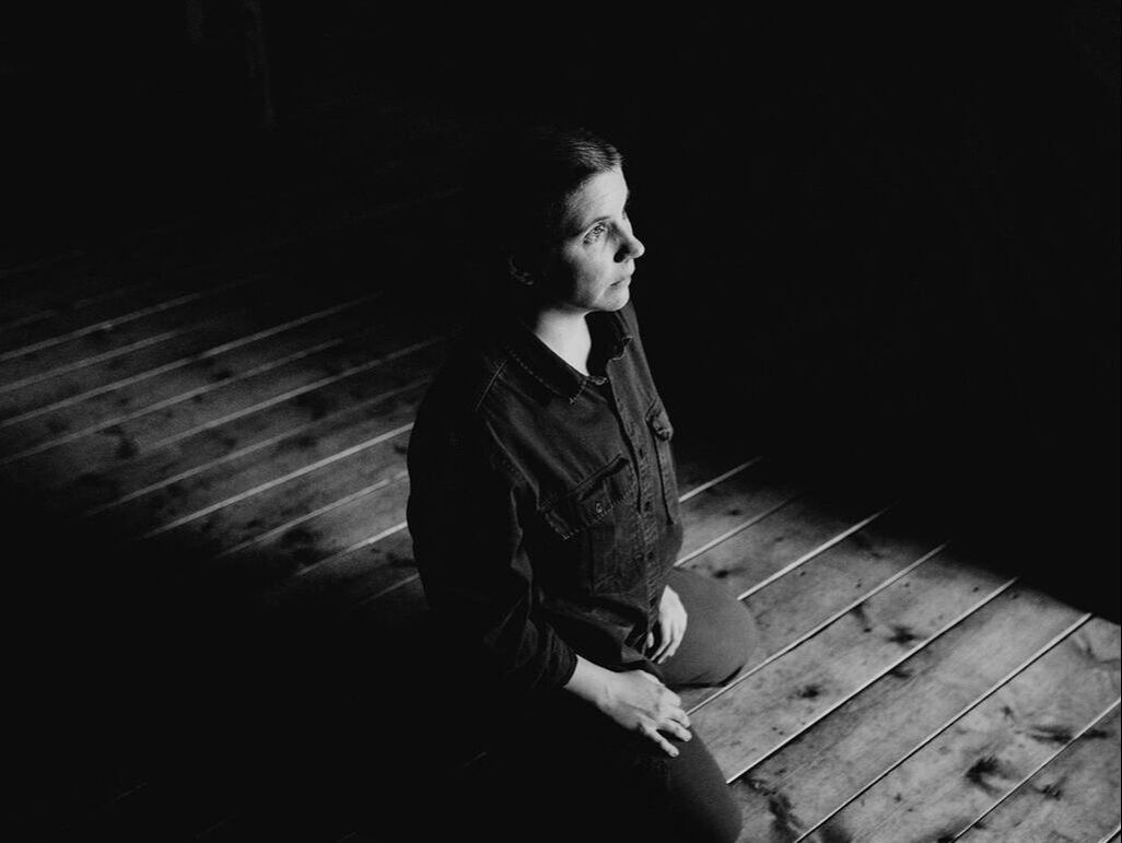 Black and white photo of Kayla Schiltgen, she is kneeling, by Adrian Steinbach