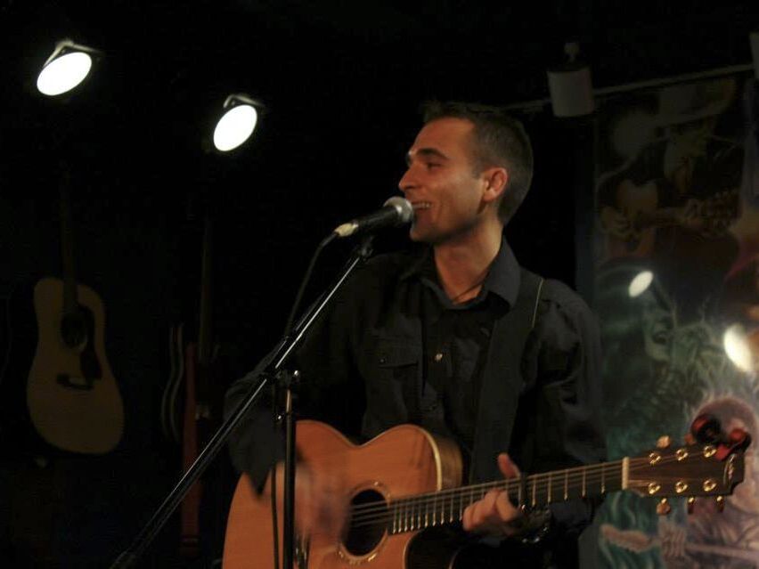 Ryan Lane sings while playing guitar