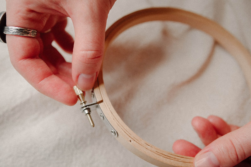 embroidery hoop and hand, close-up, photo by Kayla Schiltgen