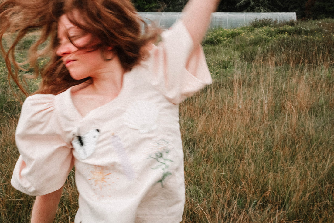 photography by North Shore photographer Kayla Schiltgen, a women dancing in an embroidered shirt