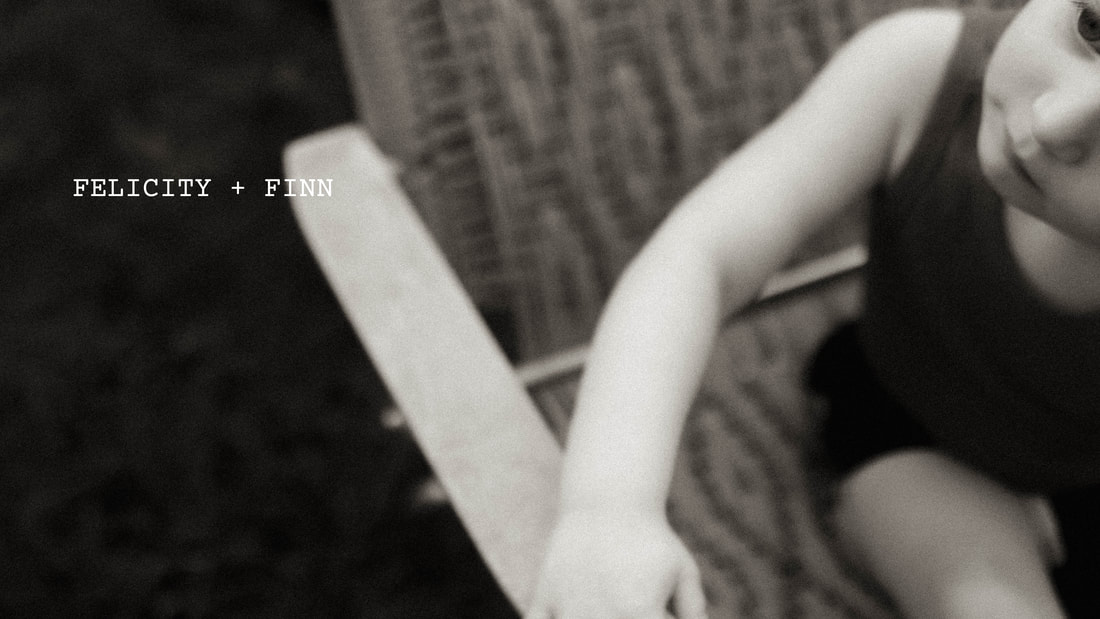 a black and white photograph by Two Harbors, Minnesota family photographer Kayla Schiltgen. A boy sitting in a vintage lawn chair.